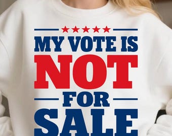 Puede incluir: Una sudadera blanca de cuello redondo con el texto MY VOTE IS NOT FOR SALE en letras negritas azules y rojas. El diseño incluye cinco estrellas rojas sobre el texto y cinco estrellas rojas debajo, dispuestas en una línea horizontal.
