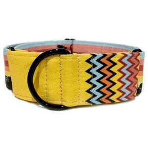 May include: Yellow dog collar with a black metal D-ring and a colorful chevron pattern.