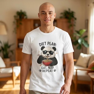 May include: White t-shirt with a graphic of a panda wearing sunglasses and eating noodles from a bowl with chopsticks. The text "DIET PLAN: EAT, NAP, REPEAT" is printed above and below the panda illustration.