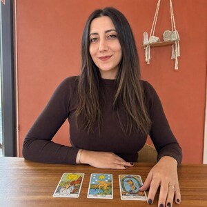 May include: Three tarot cards laid out on a wooden surface, featuring The Sun, The Star, and The World. Each card displays colorful illustrations with distinct imagery and text labels at the bottom, representing classic tarot deck iconography.