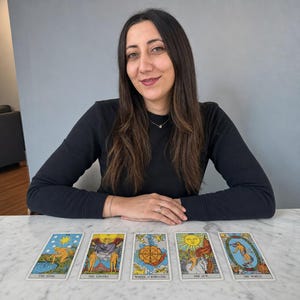 May include: A set of five tarot cards laid out in a horizontal row, featuring The Star, The Lovers, Wheel of Fortune, The Sun, and The World. Each card displays colourful, detailed illustrations with classic imagery and text labels at the bottom.