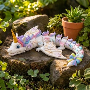 Side view of the articulated Rainbow Unicorn Dragon with floral bow details and print-in-place body design.