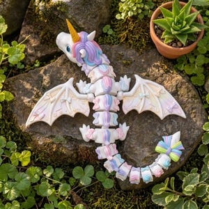 Cute kawaii Rainbow Unicorn Dragon 3D print featuring flexible body, rainbow mane, unicorn horn, and decorative bows.