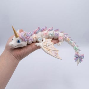 Rainbow Unicorn Dragon STL with articulated flexible body, pastel rainbow mane, floral bows, and multicolor print-in-place 3D print.