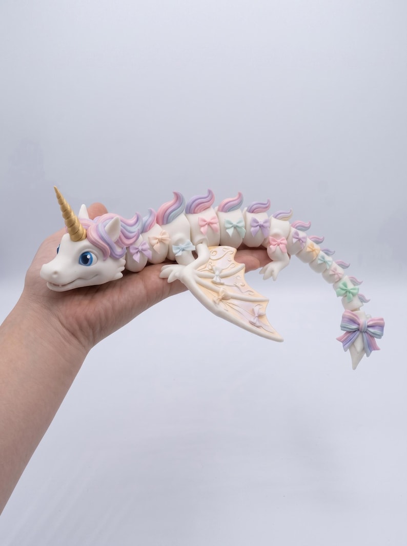 Rainbow Unicorn Dragon STL with articulated flexible body, pastel rainbow mane, floral bows, and multicolor print-in-place 3D print.