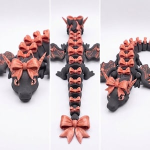 Top view of the articulated Bow Dragon displaying engraved wings, decorative bows from head to tail, and fully articulated print-in-place construction.