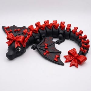 Articulated Bow Dragon STL digital download featuring a cute print-in-place fantasy dragon with decorative bows, detailed wings, and flexible body for 3D printing.