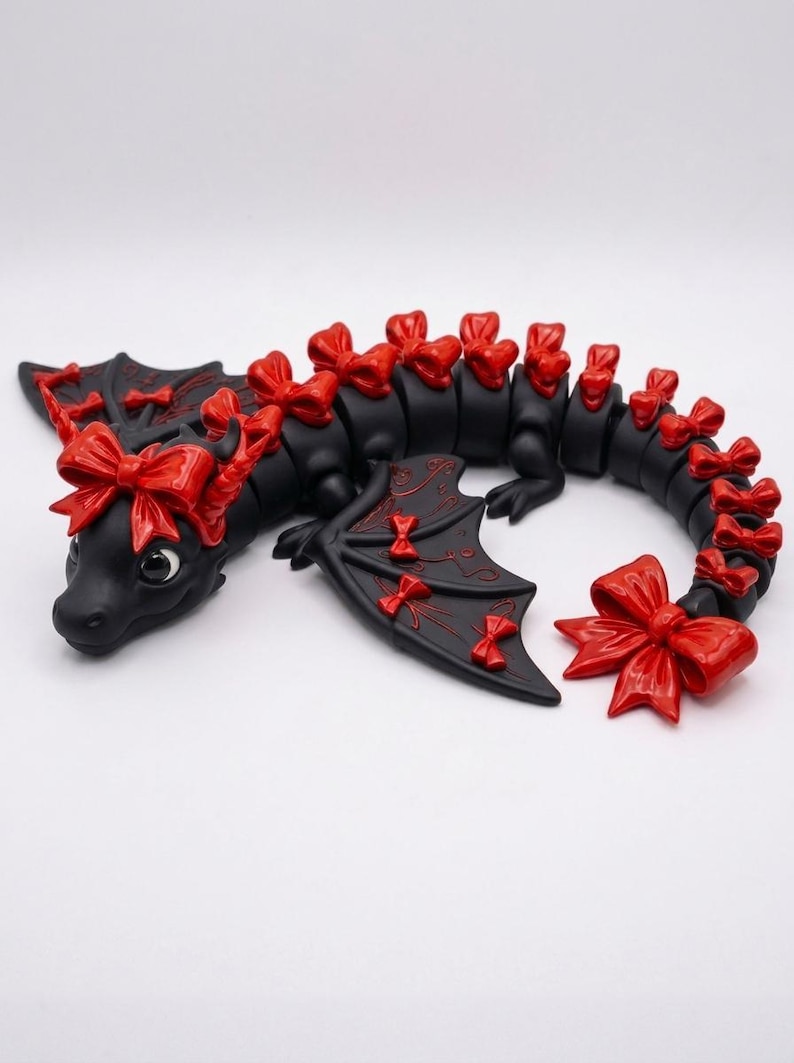 Articulated Bow Dragon STL digital download featuring a cute print-in-place fantasy dragon with decorative bows, detailed wings, and flexible body for 3D printing.