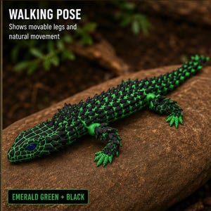 May include: An articulated lizard figurine featuring a vibrant emerald green and black color scheme with a textured, spiky back. The text WALKING POSE Shows movable legs and natural movement and EMERALD GREEN + BLACK is visible on the image.