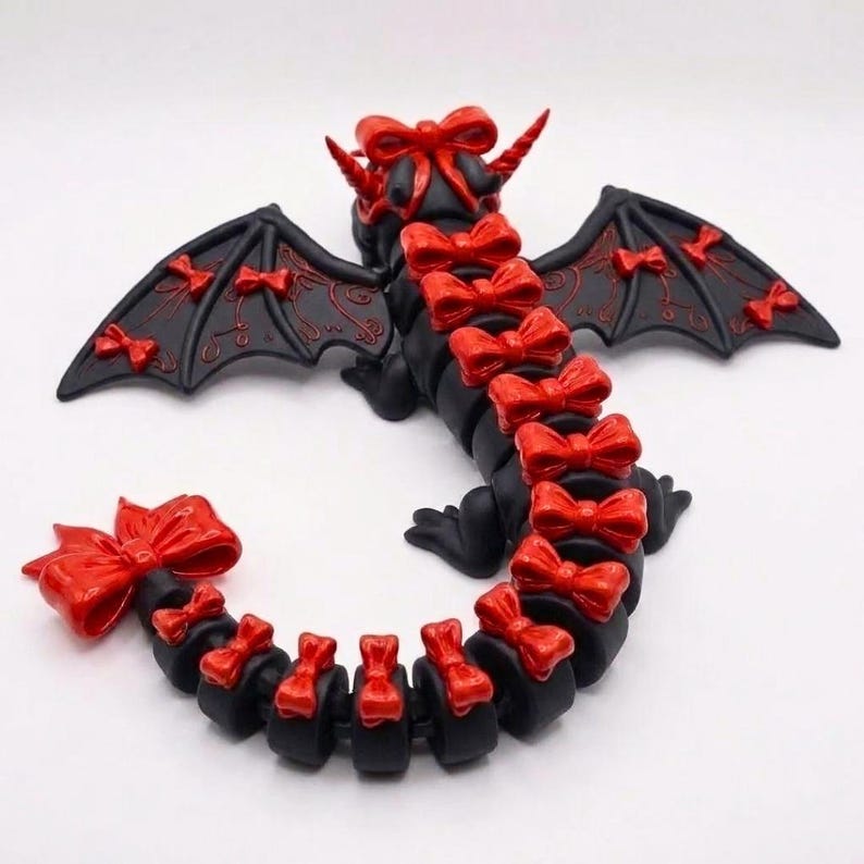 Back view of the articulated Bow Dragon STL highlighting decorative bows, detailed wings, segmented flexible tail, and print-in-place design.