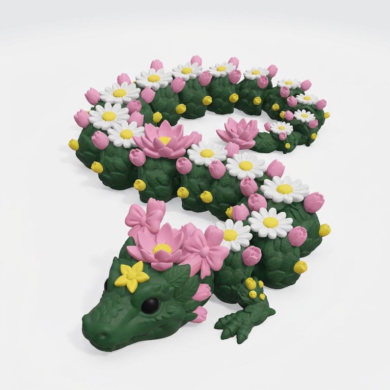 May include: A whimsical, green dragon sculpture adorned with pink lotus flowers, white daisies, and yellow accents. The dragon's body is segmented, resembling a cactus, and features detailed scales and a charming expression. A unique, decorative piece.