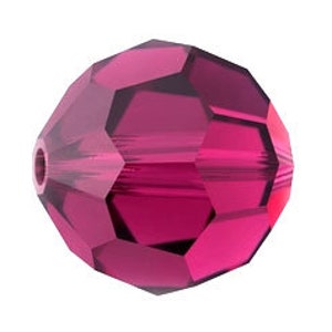 May include: A single, faceted, round, dark pink glass bead.