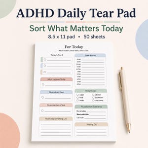 May include: ADHD daily tear pad with the text "Sort What Matters Today." The pad is 8.5 x 11 inches and has 50 sheets. It includes sections for tasks, time blocks, and body basics, with a pen resting on the side.