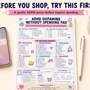 May include: A white paper notepad titled ADHD Dopamine Without Spending Pad with colorful pastel illustrations and checkboxes. The pad includes sections for tracking brain wants, dopamine types, and pre-spending checklists, alongside a smartphone and a pen.