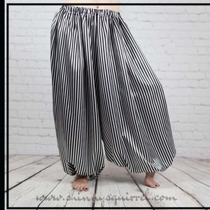 May include: Black and white striped harem pants with a wide leg and elastic waistband.