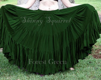 May include: A forest green, full-length, gathered skirt with multiple layers of ruffles. The skirt is made of a soft, flowing fabric and is perfect for dancing or twirling.