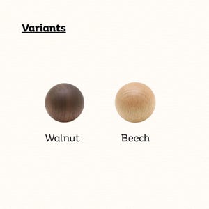 May include: Two spherical wooden knobs labeled Variants. One knob is dark brown walnut wood, and the other is light tan beech wood. The text Walnut appears below the dark sphere, and the text Beech appears below the light sphere.