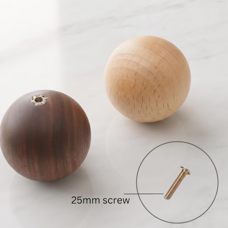 May include: Two spherical wooden knobs, one in a light natural wood tone and one in a dark brown wood tone, each featuring a central metal threaded insert. A single 25mm screw is displayed separately with a line pointing to it for scale.
