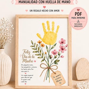 Peut inclure: Une impression encadrée avec un bouquet de fleurs d'empreintes de mains, un cadeau pour la fête des mères. L'impression comprend le texte "Joyeuse fête des mères" et "Je t'aime maman". Projet de bricolage pour enfants de 2 à 5 ans.
