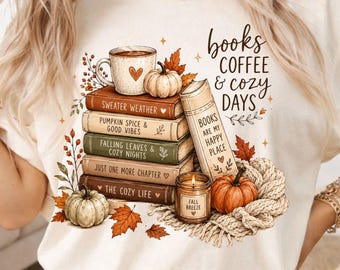 May include: A cream-colored t-shirt featuring a graphic of a stack of five books, a coffee mug, two pumpkins, a lit candle labeled Fall Breeze, and a knit blanket. The text reads Books Coffee & Cozy Days and Books Are My Happy Place.
