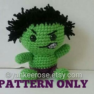 May include: Crochet pattern for a green and black Hulk amigurumi doll. The doll has a purple diaper and angry facial features. PATTERN ONLY.