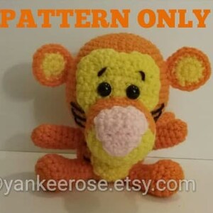 May include: Crochet pattern for a Tigger plush toy. The pattern includes instructions for making a yellow and orange Tigger with black stripes and a pink nose.
