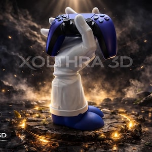 May include: A blue and black video game controller held by a white-gloved hand, part of a statue. The statue has blue feet and a white sleeve. The text "XOLTHRA 3D" is visible. The background is a dark, dramatic scene.