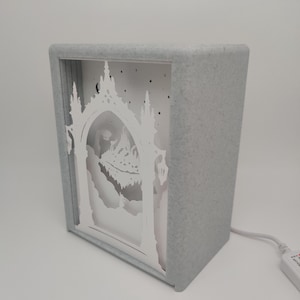 May include: A handmade wooden sign with the text "Welcome" in a playful font. The sign features a distressed white background and a dark brown frame, perfect for a front door or entryway. The sign measures approximately 12 inches wide and 6 inches tall.
