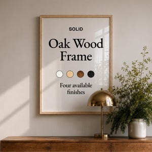 May include: A rectangular light-toned wooden frame containing a white poster with the black text "SOLID Oak Wood Frame" and "Four available finishes" above four circular colour swatches in white, light wood, dark wood, and black.