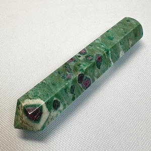 May include: A set of three ceramic mugs with a speckled, matte finish. The mugs are in shades of cream, light gray, and dark gray. Each mug has a simple, minimalist design and a rounded handle.