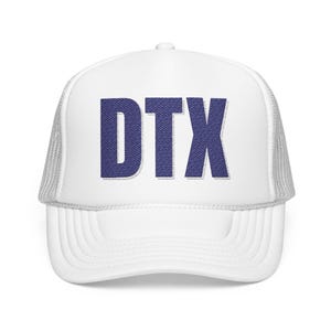 May include: White trucker hat with the embroidered letters "DTX" in a denim-like blue font. The hat features a mesh back and a curved brim, offering a classic, casual style.