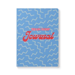 May include: A blue journal with a repeating light blue zigzag pattern. The words "BRAIN DUMP" and "Journal" are in red, retro-style lettering. The journal is rectangular and has a clean, modern design.