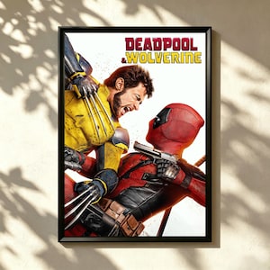 May include: Framed poster depicting Deadpool and Wolverine in a dynamic action scene. Deadpool, in a red suit and mask, aims a gun. Wolverine, in a yellow and blue suit, attacks with claws extended. The title "DEADPOOL & WOLVERINE" is at the top.