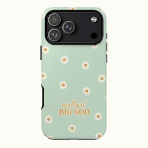 May include: A mint green phone case with a daisy pattern and the text "small girl BIG GOD" in orange. The case has a black camera module and black side buttons.
