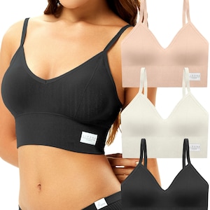 May include: A black, ribbed-texture bralette with thin straps and a V-neck design. The image also shows a matching black underwear set and three additional bralettes in beige and white. Each item has a small white label.