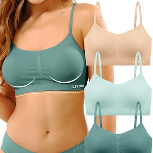 May include: A set of three seamless bralettes in beige, light mint, and dark teal, each featuring thin adjustable straps, a center ruched detail, and the brand name LIVONA printed in white on the lower right side of the fabric.