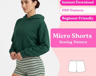 Op de afbeelding: Een donkergroene hoodie met lange mouwen, een voorzak en gestreepte micro-shorts. De afbeelding bevat de tekst Instant Download, PDF Pattern, Beginner Friendly en Micro Shorts Sewing Pattern met een lijntekening.