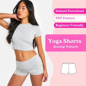 May include: A light grey short-sleeved crop top and matching shorts set. The image includes text that reads: Instant Download, PDF Pattern, Beginner Friendly, Yoga Shorts Sewing Pattern, and a line drawing of the shorts.