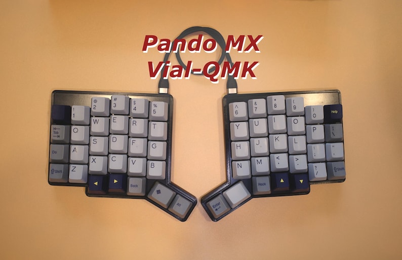 May include: A split ergonomic mechanical keyboard with light gray and dark blue keycaps, featuring the text Pando MX Vial-QMK centered above the two halves. The keyboard is connected by a black cable, with a dark frame and a non-standard layout.