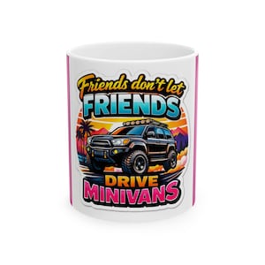 May include: White ceramic mug with a wraparound graphic. The design features a black SUV, palm trees, and the text "Friends don't let FRIENDS DRIVE MINIVANS" in a colorful, retro style. The mug has a pink accent on the rim and handle.