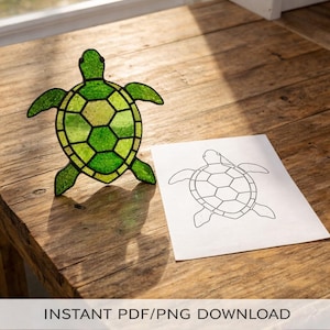 May include: A green stained glass turtle with a detailed shell pattern is displayed on a wooden surface, alongside a printed turtle outline. The turtle is made of various shades of green glass. The text "INSTANT PDF/PNG DOWNLOAD" is visible at the bottom.