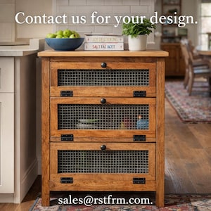 May include: Wooden kitchen cabinet with three wire mesh front drawers. The cabinet is topped with a blue bowl of green apples, cookbooks, and a potted plant. The text "Contact us for your design" and the email address sales@rstfrm.com are visible.