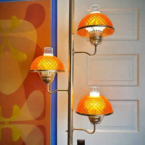 May include: A set of three ceramic mugs with a speckled, matte finish. The mugs are in shades of cream, light gray, and dark gray. Each mug has a simple, minimalist design and a rounded handle.