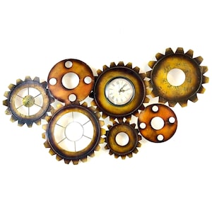 May include: A wall clock made of metal gears in shades of brown and gold. The clock face is white with black Roman numeral hour markers and black hands.