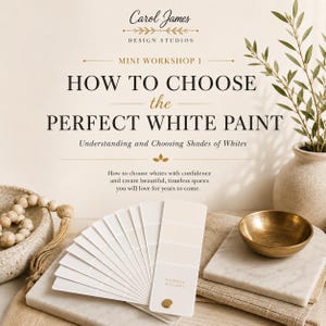 May include: A promotional graphic titled Carol James Design Studios Mini Workshop 1 How to Choose the Perfect White Paint. It features a fan deck of white paint swatches, a brass bowl, a marble slab, and a wooden bead garland.