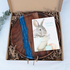 May include: A set of three ceramic mugs with a speckled, matte finish. Each mug features a different color: light blue, cream, and gray. The mugs have a simple, modern design and a comfortable handle.
