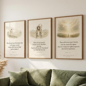 Jesus Leaves the 99 modern minimalist scripture set of three, warm cream prints in thin oak frames arranged on a sage green linen wall above a natural rattan sofa, dried pampas grass in a terracotta vase, soft afternoon light filtering from the left, clean farmhouse living room, christian wall art digital download from TheFramedVerse on Etsy