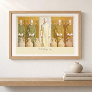 Shelf mockup of The Wedding at Cana in a light oak frame resting on a pale wood surface beside stacked neutral books and a rounded ceramic vase. The framed print shows Christ centered between six complete stone jars, with three on the left and three on the right. Cream matting, soft wall texture, and natural light present the horizontal Bible artwork at an easy domestic scale.