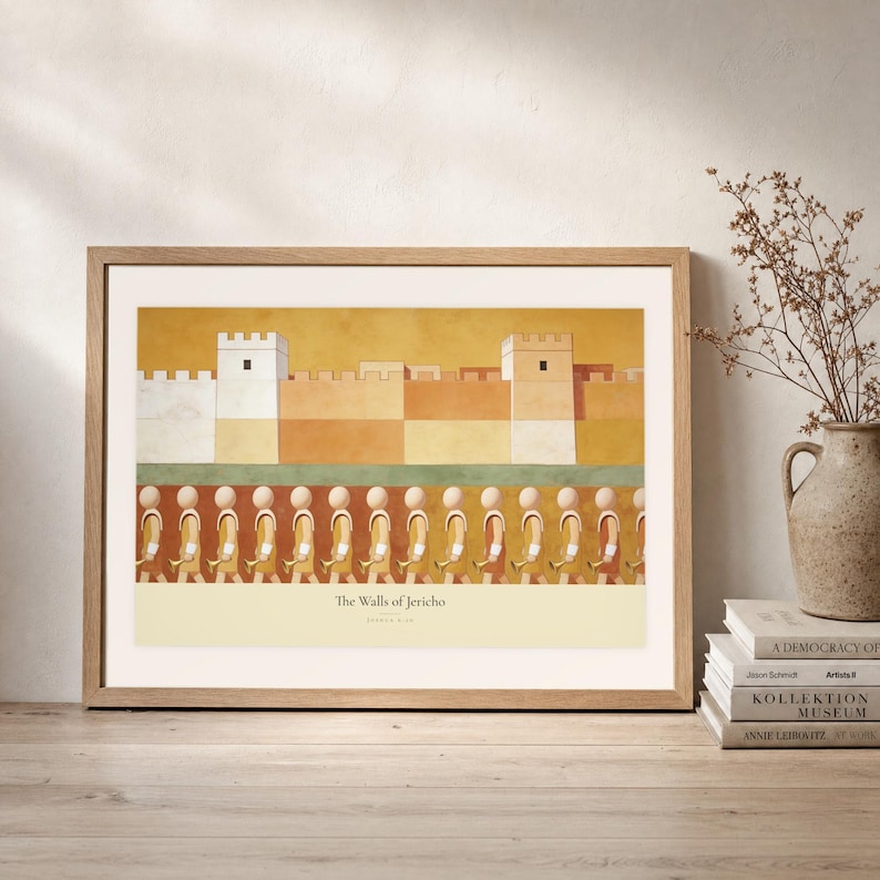 Leaning frame mockup of The Walls of Jericho on a rustic wood console beside stacked art books and a tall ceramic vessel with dried stems. The print shows a fortified ochre city above a passing line of faceless horn bearers. The oak frame, broad cream mat, plaster wall, and soft side light create a relaxed display while keeping the title and Joshua 6:20 legible.