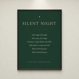 Silent Night Christmas print shown straight on in a slim black frame against a light neutral background. The deep forest green design includes cream serif typography, a gold star ornament, the centered first verse, and a Traditional Christmas Hymn footer. Clean, balanced Christian Christmas decor with the feel of a classic minimalist holiday print.
